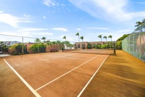 a tennis court with two tennis rackets on it at Kuleana Club #510 - Ocean View -1 bedroom & 1 bathroom - 2nd Floor in Kahana