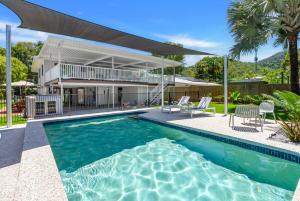 an exterior view of a house with a swimming pool at Belle Escapes Endeavour To Impress in Clifton Beach