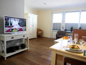 Una televisión o centro de entretenimiento en Hochwertiges und komfortables 1-Zimmer-Appartement mit Balkon