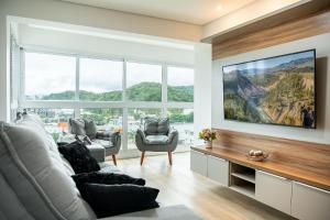 a living room with a view of a mountain at Riviera Concept 2 dorm by Achei Camboriú in Itajaí