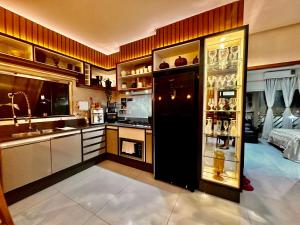 a kitchen with a sink and a refrigerator at Loft dos sonhos cobertura in Boa Vista