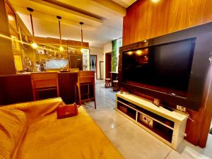a living room with a large flat screen tv at Loft dos sonhos cobertura in Boa Vista