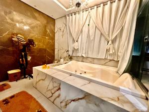 a bathroom with a white tub and a window at Loft dos sonhos cobertura in Boa Vista +37 photos