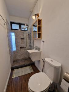 a bathroom with a toilet and a sink at BLUE BEACH APARTMENT in Blue Bay +18 photos