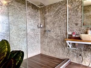 a bathroom with a shower and a sink at Bella Lunar Villa ดอยแม่สลอง in Mae Salong
