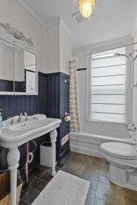 a bathroom with a sink and a toilet and a tub at Victoria Family Home King Patio 2 Ba Bbq in St. John's
