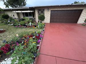 a red driveway in front of a house with flowers at Retreats at Fort-Lauderdale in Margate