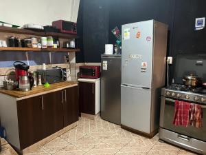 a kitchen with stainless steel refrigerators in a kitchen at Hostal Perro Watón in Valparaíso