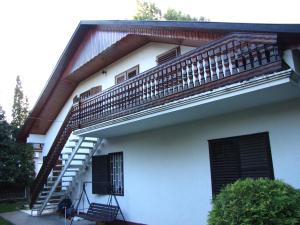 a house with a staircase on the side of it at Schmidt apartment in Balatonfenyves