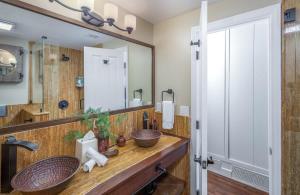 a bathroom with a sink and a large mirror at Ocean Dreamin in Encinitas +27 photos