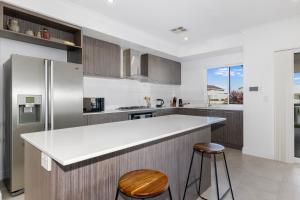Una cocina con encimera blanca y refrigerador. en Windward Marina Retreat, en Geographe