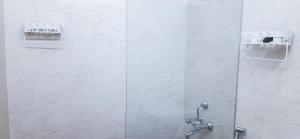 a shower in a bathroom with a glass door at HappyHuts at Green valley view in Kodaikānāl +37 photos