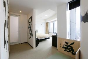 a bedroom with a bed and a window at Park Hotel Tokyo in Tokyo