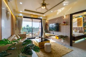 a living room with a couch and a table at Goa Riviera in Goa