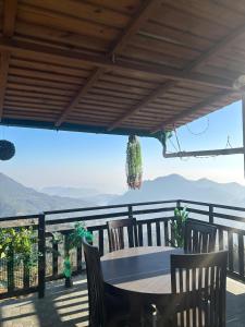 a table and chairs on a balcony with a view at Baakhli Guest House and Restaurant in Bhowāli +27 photos