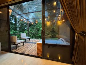 a glass door leading to a hot tub on a deck at River Paradise Cabin with Private Jacuzzi in Fortuna