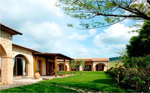 an exterior view of a house with a yard at Bio Agriturismo Le Cascatelle in Saturnia