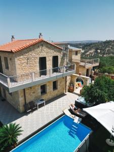 an external view of a house with a swimming pool at Emily Maria Fine Living in Filakí