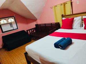 a bedroom with two beds with red and yellow walls at EntireHouse n Panglao FastWiFi AC HotShowers Netflix in Dauis