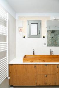 a bathroom with a wooden sink and a mirror at Emily Maria Fine Living in Filakí