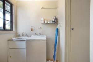 a laundry room with a washing machine and a window at Three Bedroom Sweet Retreat in Coburg in Melbourne