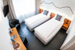 Voodi või voodid majutusasutuse Hotel Merkur - West Station toas