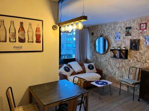 a living room with a couch and a table at les Loulous Réallon in Réallon
