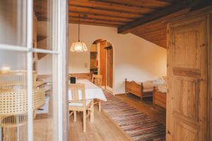 a dining room with a table and a bedroom at Demeterhof Knolln in Söll