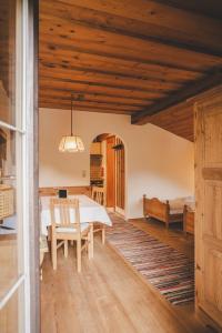 a dining room with a table and a bedroom at Demeterhof Knolln in Söll +46 photos