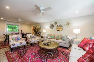 a living room with a couch and a table at Blissful Bay at Bayside Bungalow in Anna Maria