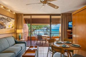a living room with a couch and a table at Kuleana Club #722 Oceanfront - 1 bedroom & 1 bathroom - 3rd Floor in Kahana