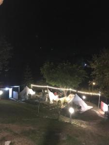 a group of tents in a park at night at Hangout Khaokho รีสอร์ตG3 in Phetchabun