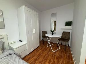 a small room with a table and a bed at One Room Apartment Ptm 3 in Bucharest