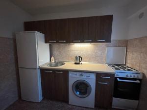 a small kitchen with a sink and a washer at One Room Apartment Ptm 3 in Bucharest