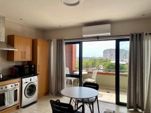 a kitchen with a table and a view of a city at Studio in the City in Cape Town
