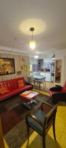 a living room with a red couch and a table at Vintage in Perpignan in Perpignan +52 photos