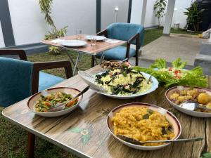 a wooden table with plates of food on it at Ceylon Seascape Villa in Beruwala