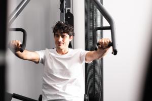 a man in a gym lifting weights at Athenian Riviera Hotel& Suites in Athens