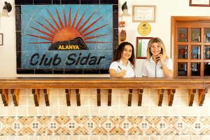 two women standing behind a counter in a restaurant at Club Sidar Apart Hotel in Alanya +79 photos