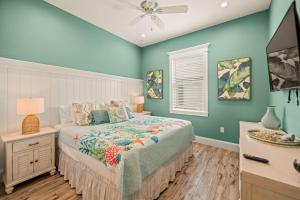 a bedroom with a bed and a ceiling fan at Endless Summer in Anna Maria +48 photos