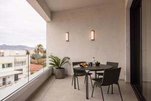 a dining room with a table and chairs on a balcony at Interlace by Holistays in İncirli