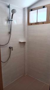 a bathroom with a shower with a glass door at Koh Mook Sivalai Beach Resort in Ko Mook
