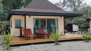 a gazebo with two chairs and a table at Koh Mook Sivalai Beach Resort in Ko Mook