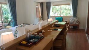 a hotel room with a bed and tables in a room at Koh Mook Sivalai Beach Resort in Ko Mook