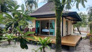 a guest house with a deck and a bedroom at Koh Mook Sivalai Beach Resort in Ko Mook