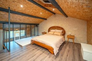 a bedroom with a bed in a room with windows at Le Mas de l Olivier in Poulan-Pouzols +21 photos
