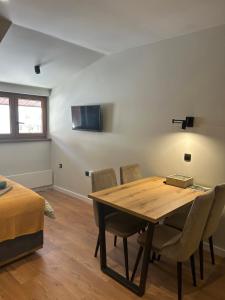 a room with a table and chairs and a bed at Bela Reka C308 in Brzeće