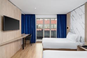 Télévision ou salle de divertissement dans l'établissement Rihab Hotel