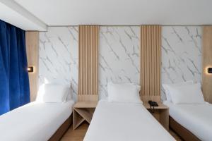 Un ou plusieurs lits dans un hébergement de l'établissement Rihab Hotel