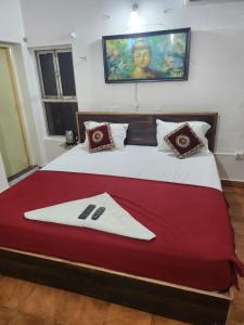a bedroom with a large bed with a napkin on it at Sea Doll 7th floor in Visakhapatnam +6 photos